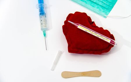 Photo of the Syringe injecting a red heart and health concept, healthy life
