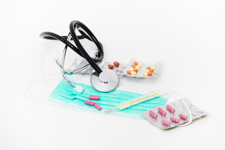 Photo of the Set for flu treatment -  pills, thermometer, nasal sprays, protective surgical mask, stethoscope, syringe...の写真素材