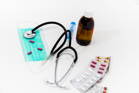 Photo of the Set for flu treatment -  pills, thermometer, nasal sprays, protective surgical mask, stethoscope, syringe...の写真素材