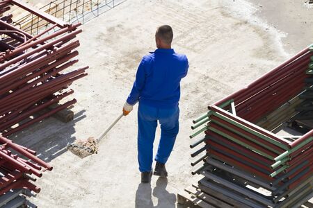 Photo of the Worker works with a shovel, cleaning rubble