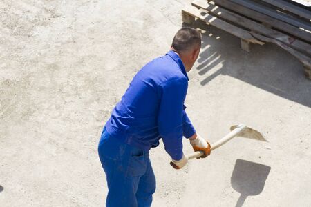 Photo of the Worker works with a shovel, cleaning rubbleの写真素材