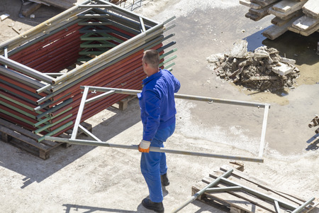 Photo of the Worker works with a shovel, cleaning rubble