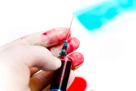 Photo of the Syringe in laboratory environment, blood and medical accessoriesの写真素材