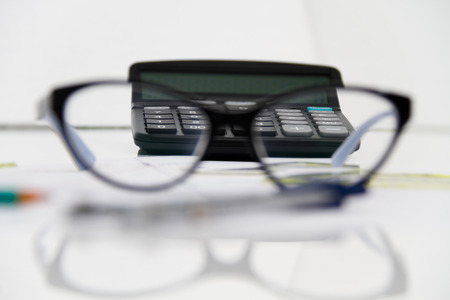 Photo of the Business Architectural project, pair of compasses, glasses, rulers and calculator - business conceptの写真素材