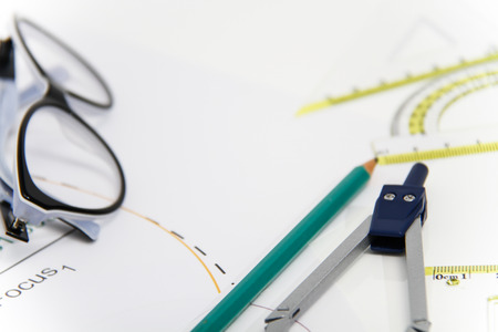 Photo of the Business Architectural project, pair of compasses, glasses, rulers and calculator -...