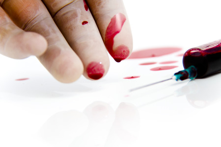 Photo of the Syringe in laboratory environment, blood and medical accessories