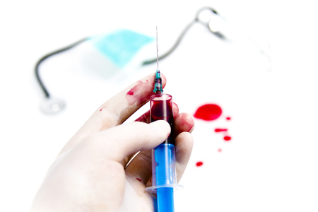 Photo of the Syringe in laboratory environment, blood and medical accessoriesの写真素材