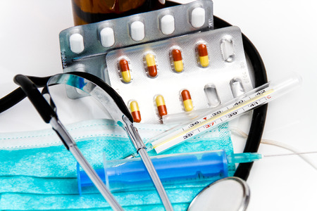 Photo of the Set for flu treatment, thermometer, nasal sprays, protective surgical mask, stethoscope, syringe...の写真素材