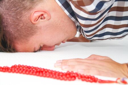 Photo of the Young Muslim Man Is Praying