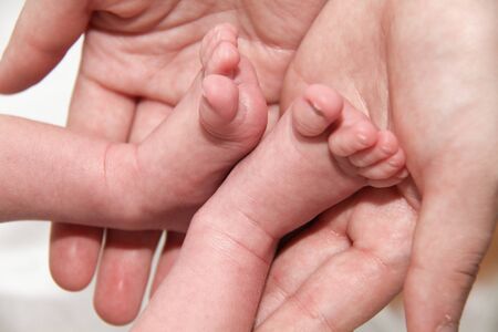 Photo of the Baby's foot in mother hands