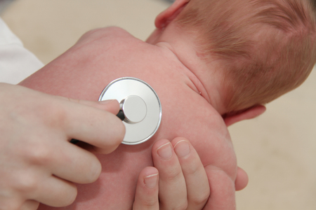 Photo of teh Male Baby gets a lung examination by a nurse with stethoscopeの写真素材