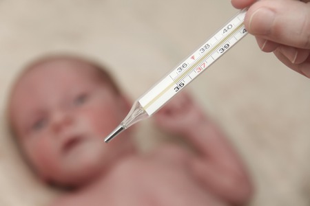 Photo of the Measuring the temperature of  baby in thermometerの写真素材