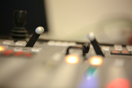 Photo of the TV editor working with video and audio mixer