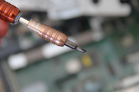 Computer repair concept Close-up view. Computer service. Man repairing notebook at the tableの写真素材