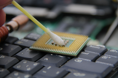 Computer repair concept Close-up view. Computer service. Man repairing notebook at the tableの写真素材