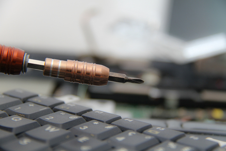 Computer repair concept Close-up view. Computer service. Man repairing notebook at the tableの写真素材