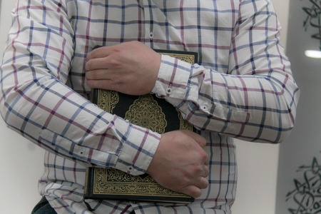 Young muslim man reading the Quran - holy book of Muslimsの写真素材