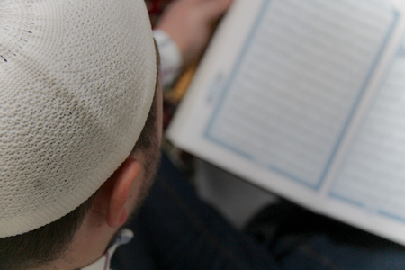 Young muslim man reading the Quran - holy book of Muslimsの写真素材