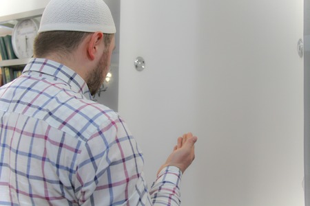 Young muslim man praying inside of beautiful mosqueの写真素材