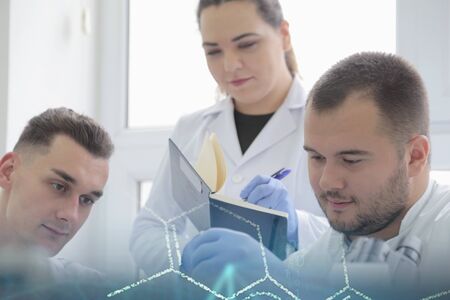 Group of young Laboratory scientists working at lab with test tubes and microscope, test or research...