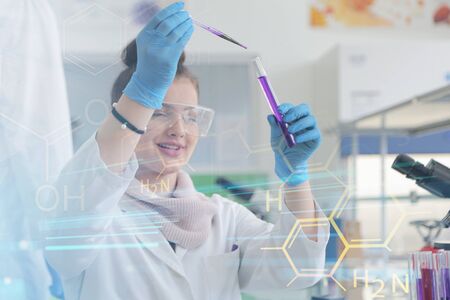 Young female Laboratory scientist working at lab with test tubes and microscope, test or research in...
