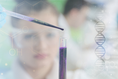 Two Young Female and male Laboratory scientists working at lab with test tubes and microscope, test or research in clinical laboratory.Science, chemistry, biology, medicine and people concept.の写真素材