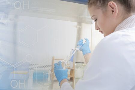 Young female Laboratory scientist working at lab with test tubes and microscope, test or research in...