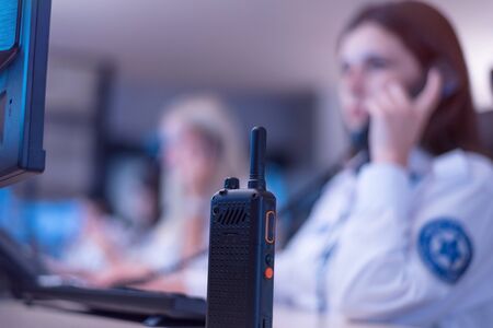 Security guard monitoring modern CCTV cameras in surveillance room.  Male security guard in...