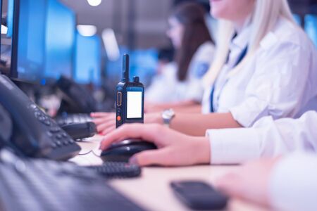 Security guard monitoring modern CCTV cameras in surveillance room. Group of  Female security guards...