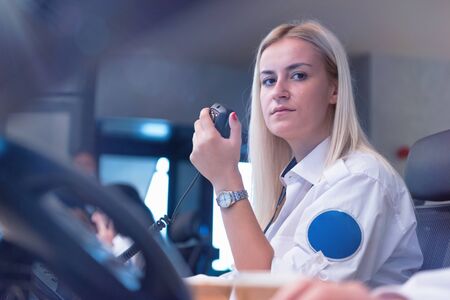 Security guard monitoring modern CCTV cameras in surveillance room. Female security guard in...