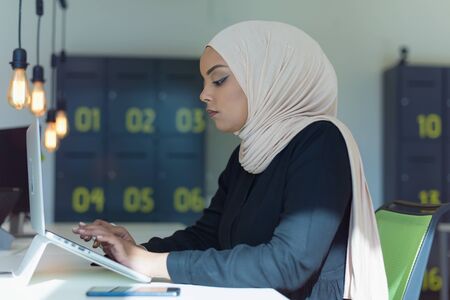 Young muslim African American business woman as a leader at work. Teamwork and multiethnic concept. Happy successful business leader working at her office.の写真素材