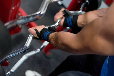 Hard Core Bodybuilding. Muscular athletic bodybuilder fitness model training arms with dumbbells in gym. Concept sport photo of exercises in gymの写真素材