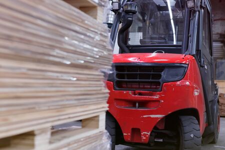 Timber Flooring Factory. Pile of cut wood in factory storage warehouse. Lumber in warehouse.の写真素材