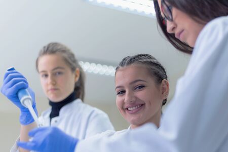 Group of  Laboratory scientists working at lab with test tubes, test or research in clinical laboratory.Science, chemistry, biology, medicine and people concept.の写真素材