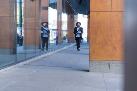 Portrait Of young Businessman  Outside Office. Meeting Concept. Man Walking and drinking coffe,...