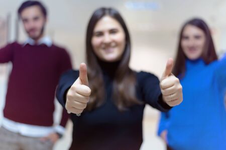 Business, education and sucess concept, Group of Young business people standing and looking at camera with finger up.の写真素材