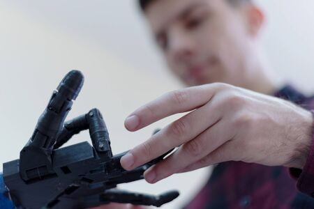 Scientists engineers designing small human robot, setting artificial intelligence humanoid robot. Artificial intelligence, futuristic and smart robots concept.の写真素材