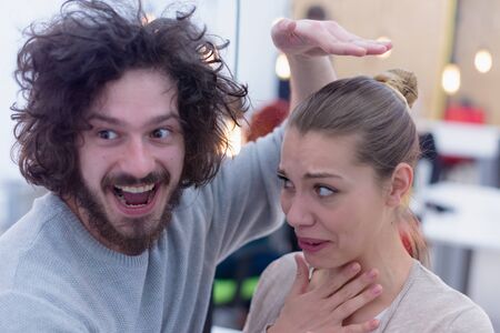Two Creative office workers collaborate together making joke with each other during their work...