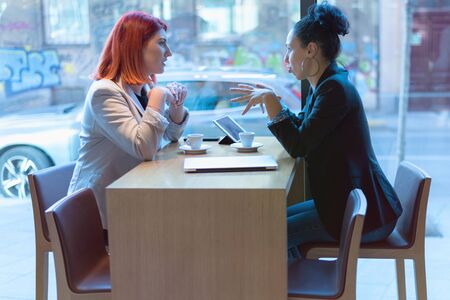 Startup Diversity Teamwork Brainstorming Meeting Concept.Two Business Coworkers Sharing World Economy Report Document Laptop.People Working Planning Start Up.Young Hipsters Discussing Cafeの写真素材