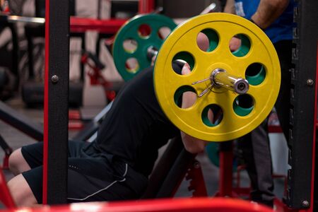 Hard Core Bodybuilding. Muscular athletic bodybuilder fitness model training arms with dumbbells in gym. Concept sport photo of exercises in gymの写真素材