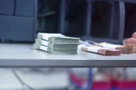 Bank employees sorting and counting money inside bank vault. Large amounts of money in the bank.の写真素材