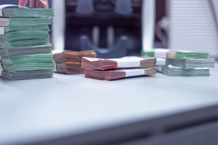 Bank employees sorting and counting money inside bank vault. Large amounts of money in the bank.の写真素材