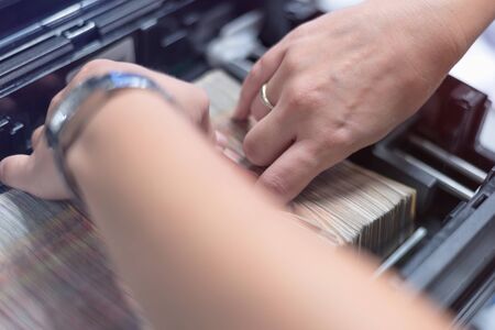Bank employees sorting and counting money inside bank vault. Large amounts of money in the bank.の写真素材