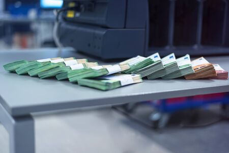 Bank employees sorting and counting money inside bank vault. Large amounts of money in the bank.の写真素材