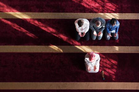 Group of young Muslim people praying. Muslim prayers doing a pray inside the mosque.の写真素材