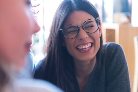 Young female busuness women discussing about new projects  in a local restaurant. Hapiness and...