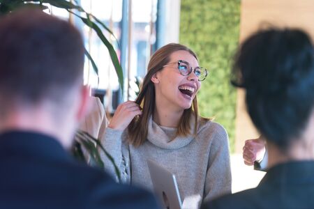 Young business people talking with each other about new projects at a coffee barの写真素材