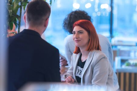 Young business people talking with each other about new projects at a coffee barの写真素材