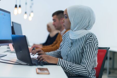 Young muslim African American business woman as a leader at work. Teamwork and multiethnic concept....