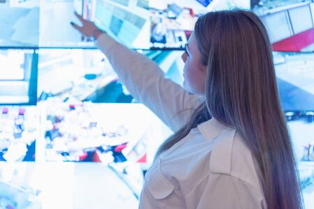 Security guard monitoring modern CCTV cameras in surveillance room. Female security guard in...